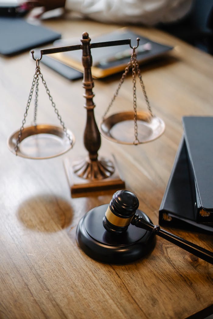 About High angle lawyers desk with decorative judgement scales and gavel in modern law firm